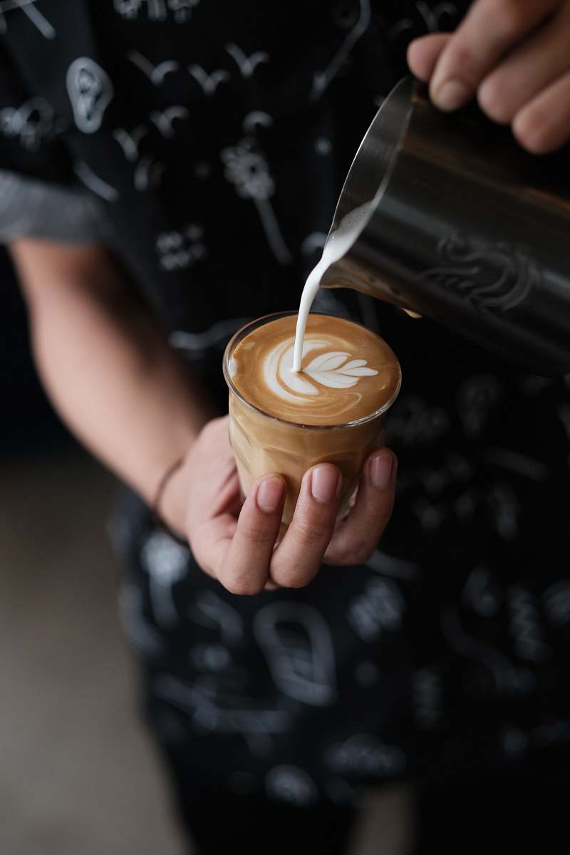 coffee cup person holding cup of coffee pouring milk drink